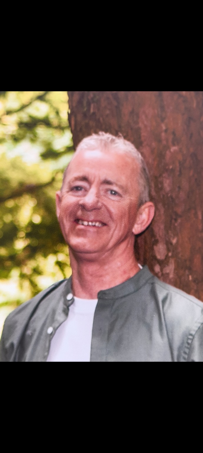 Steve outdoors, leaning against a tree